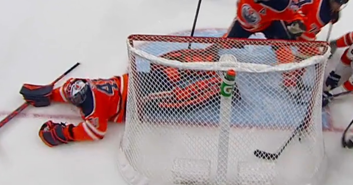 Oilers goalie Mike Smith goes down after a hard shot to his nether region.