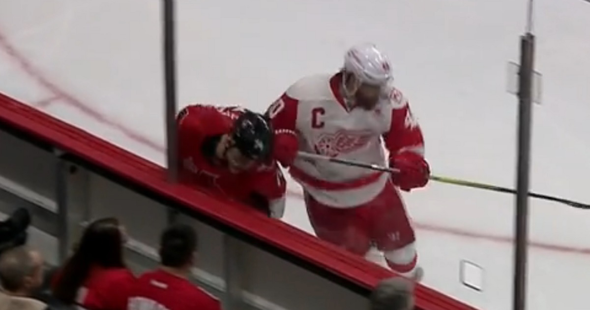 Wings captain Henrik Zetterberg delivers an out-of-character hit from behind.