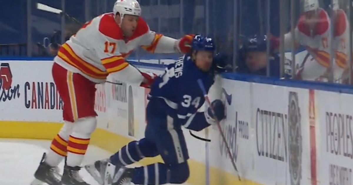 Milan Lucic sends Auston Matthews into the boards with a hit from behind.