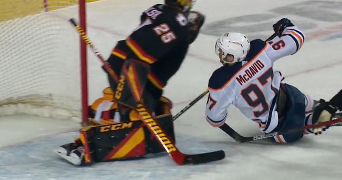 Connor McDavid slams into Jacob Markstrom.