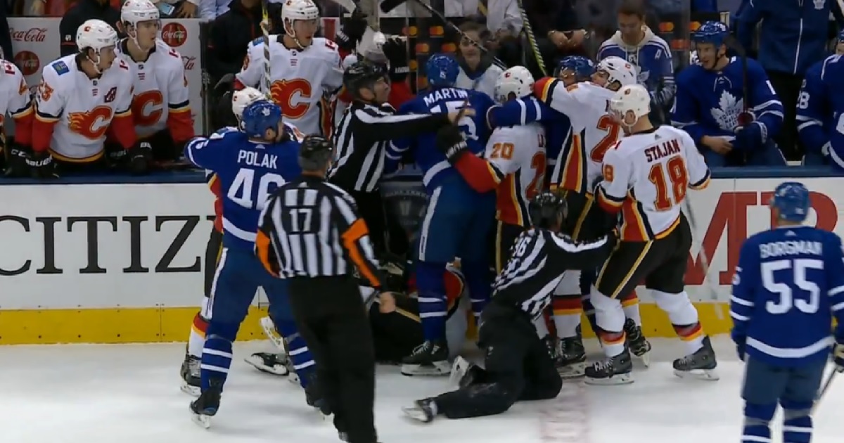 Matthew Tkachuk spears Matt Martin from the bench during wild scrum.