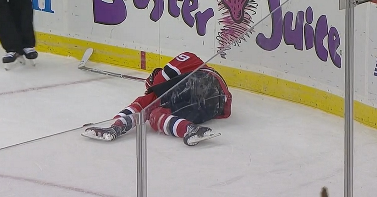 Player appears badly hurt after being pushed head first into the boards.