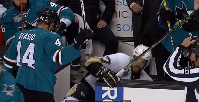 Vlasic shoves Crosby in to the Sharks bench.