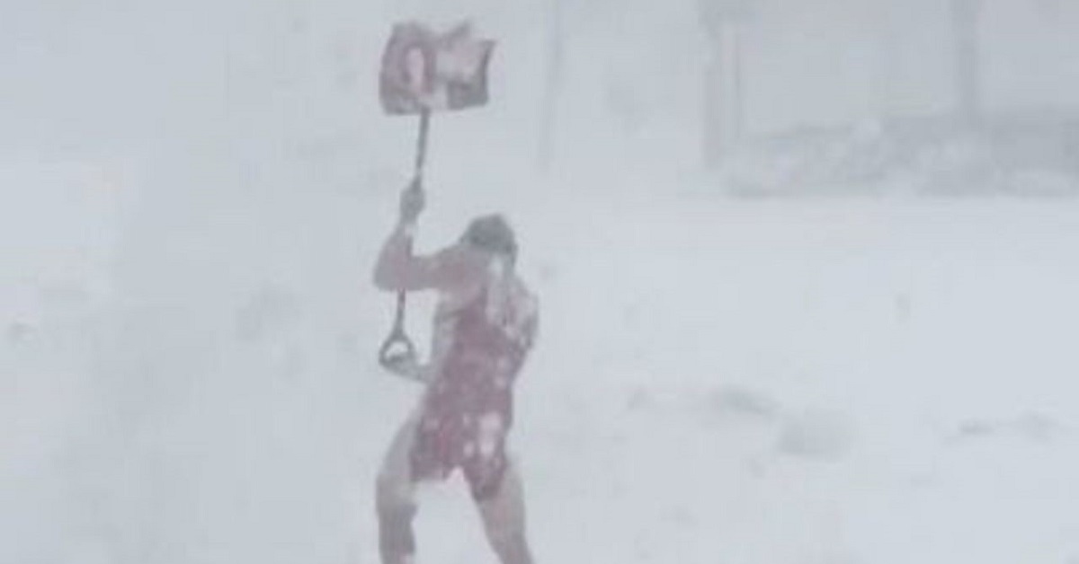 High school wrestler shovels snow in nothing but his wrestling gear.