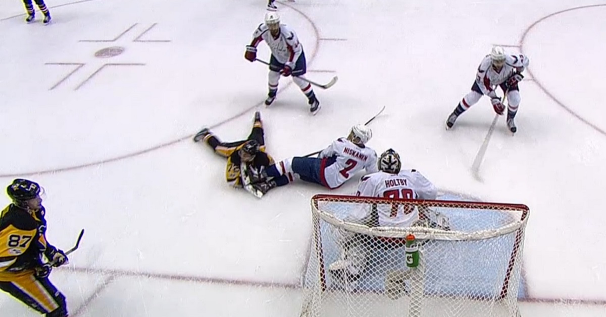 Penguins forward falls to the ice and takes a skate to the face!