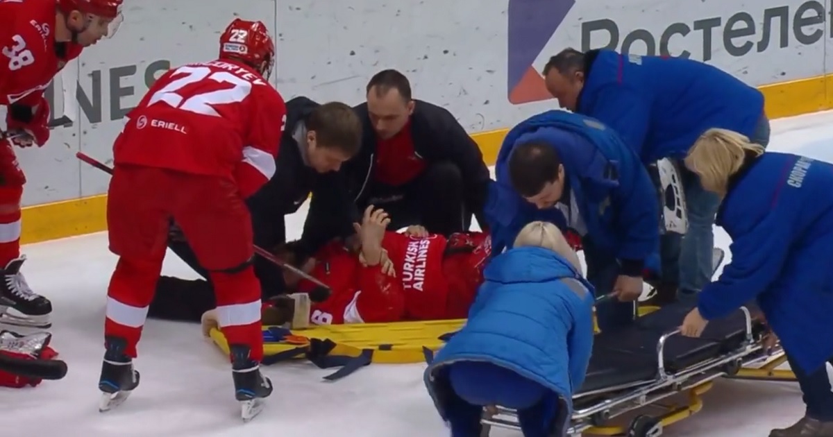 Former NHLer leaves on a stretcher after goalie sends him head first into the boards.