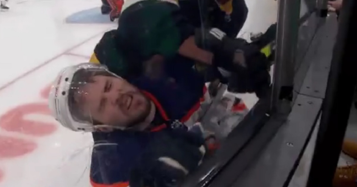 Brad Marchand drives Kris Russell into the boards from behind. 